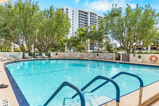 a living room with couches a coffee table and with outer view