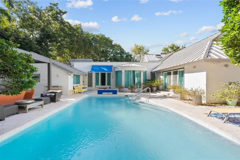 a view of a house with swimming pool and sitting area