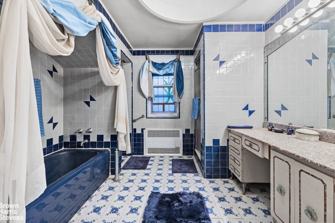 1702 East 28th Street Brooklyn, NY 11229 - Photo 16 of 17 a bathroom with a sink a vanity and a mirror