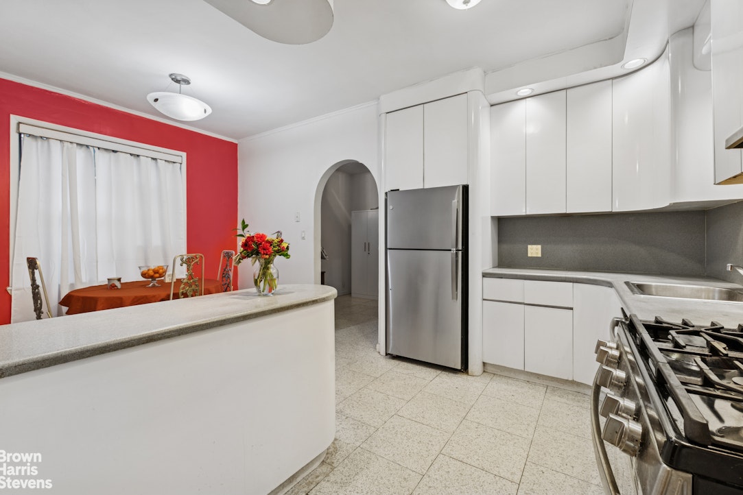 1702 East 28th Street Brooklyn, NY 11229 - Photo 8 of 17 a kitchen with stainless steel appliances granite countertop a refrigerator and a stove top oven