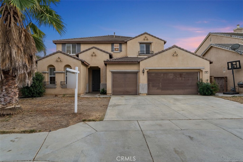 front view of a house with a yard and a garage