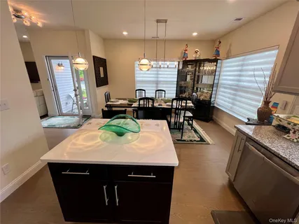 a kitchen with stainless steel appliances granite countertop a stove a sink dishwasher a refrigerator and a microwave