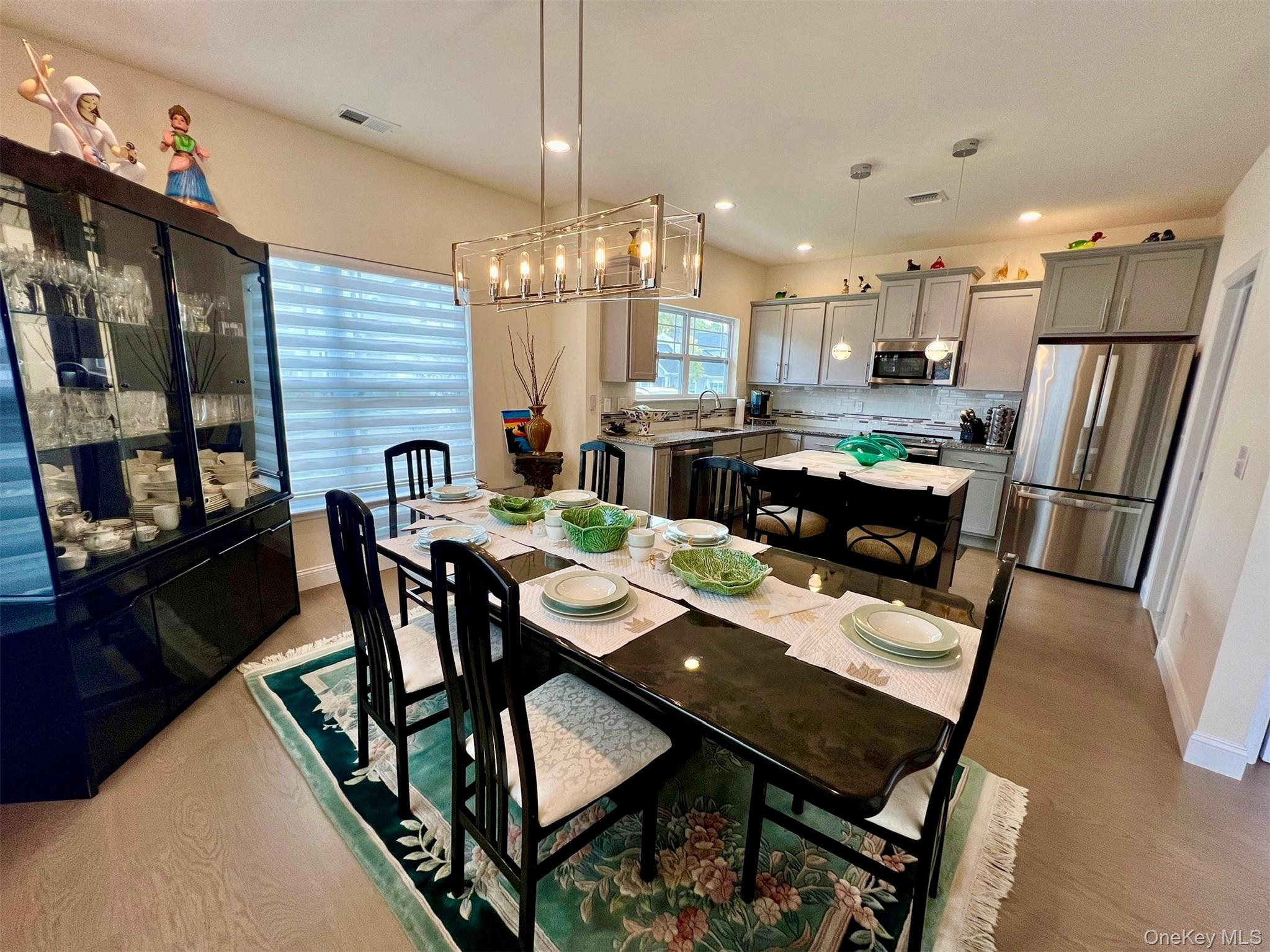 37 Willow Circle, Unit 37 Coram, NY 11727 - Photo 17 of 18 a view of a dining room with furniture window and wooden floor