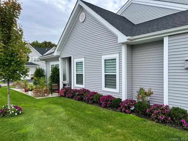 a front view of a house with a yard and outdoor seating