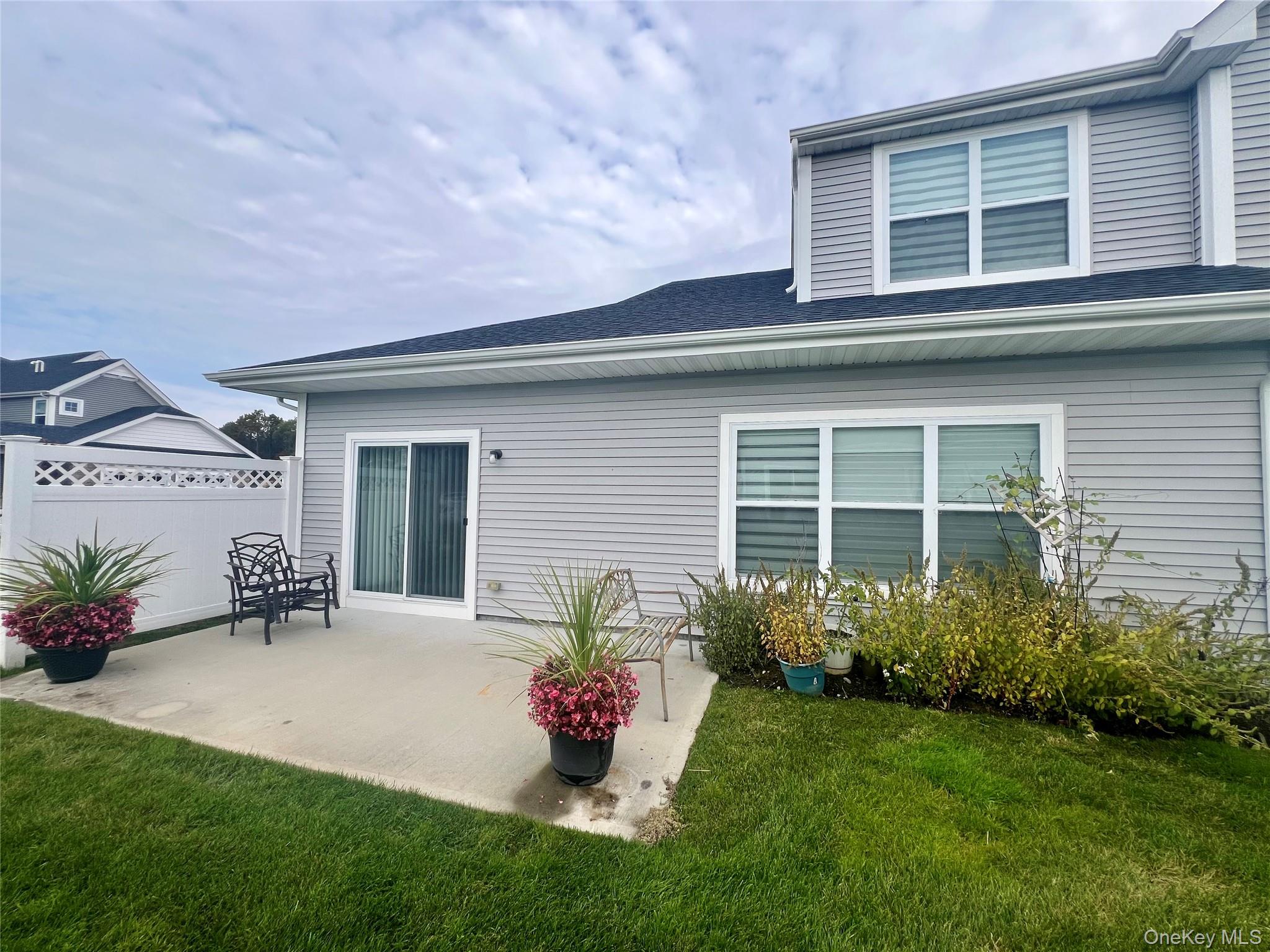 37 Willow Circle, Unit 37 Coram, NY 11727 - Photo 8 of 18 a front view of a house with a garden and patio
