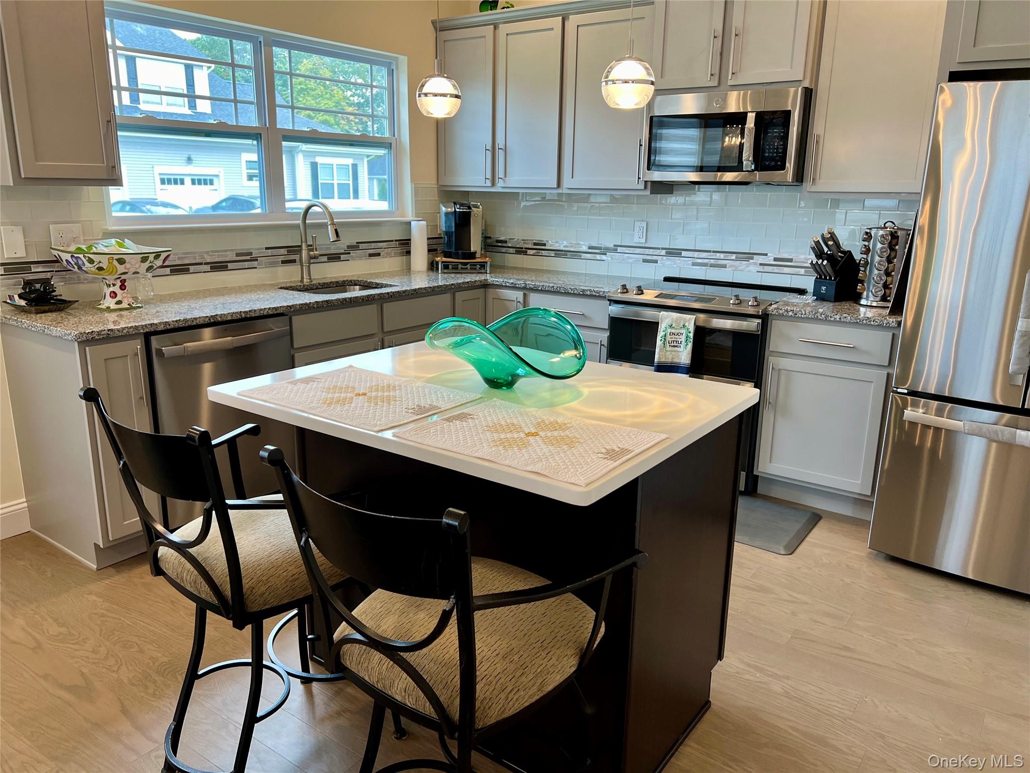 37 Willow Circle, Unit 37 Coram, NY 11727 - Photo 9 of 18 a kitchen with granite countertop a sink appliances and cabinets