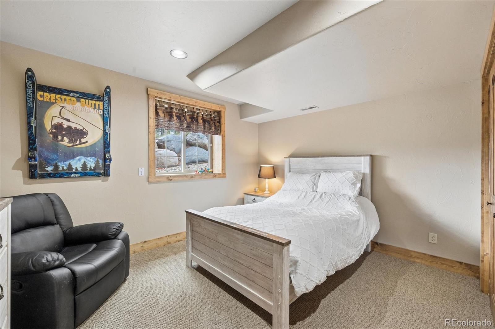 2894 County Road 43 Bailey, CO 80421 - Photo 21 of 40 a bedroom with a bed and a couch