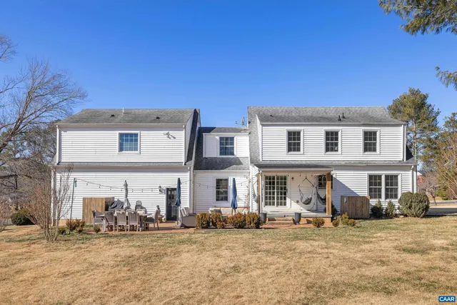 a dining room with lots of furniture and a book shelf