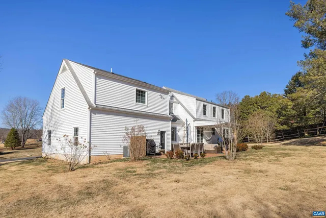 a dining room with furniture a window and a chandelier