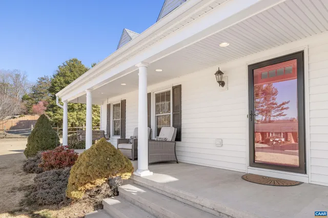 a kitchen with white cabinets and sink