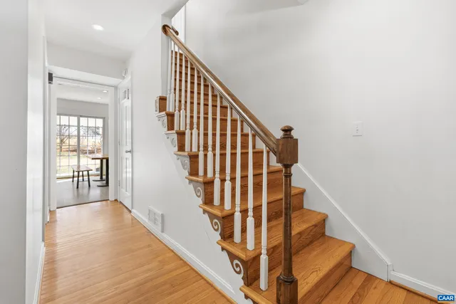 a spacious bedroom with a bed and a book shelf