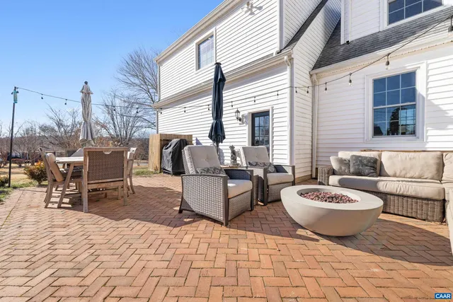 a view of a patio with a table and chairs and potted plants
