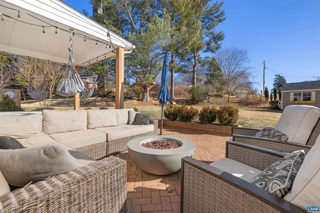 a view of a house with a yard and tree s