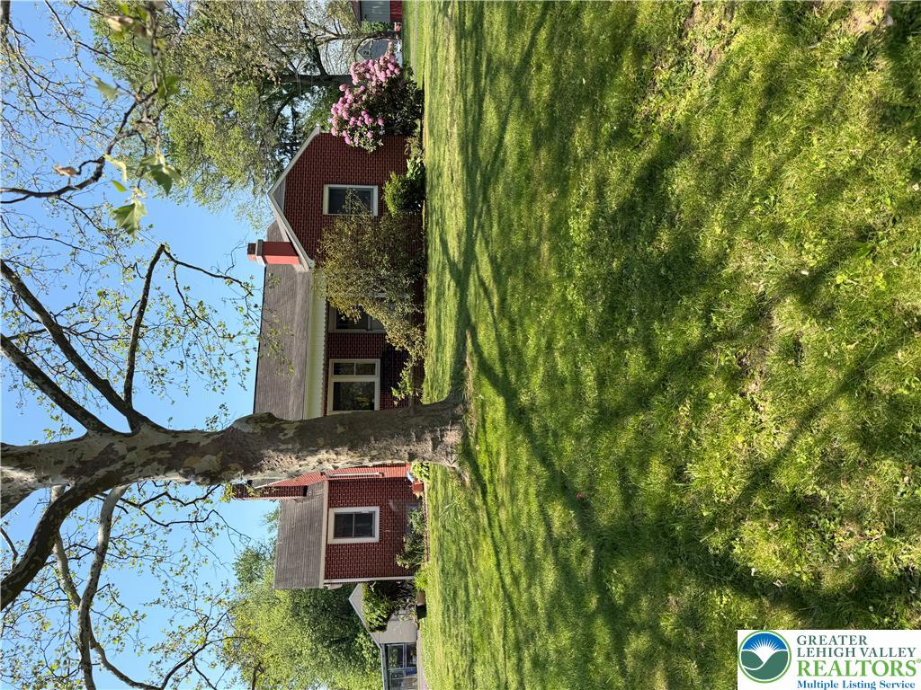 1340 Cowpath Road Hatfield, PA 19440 - Photo 1 of 16 a front view of a house with a garden