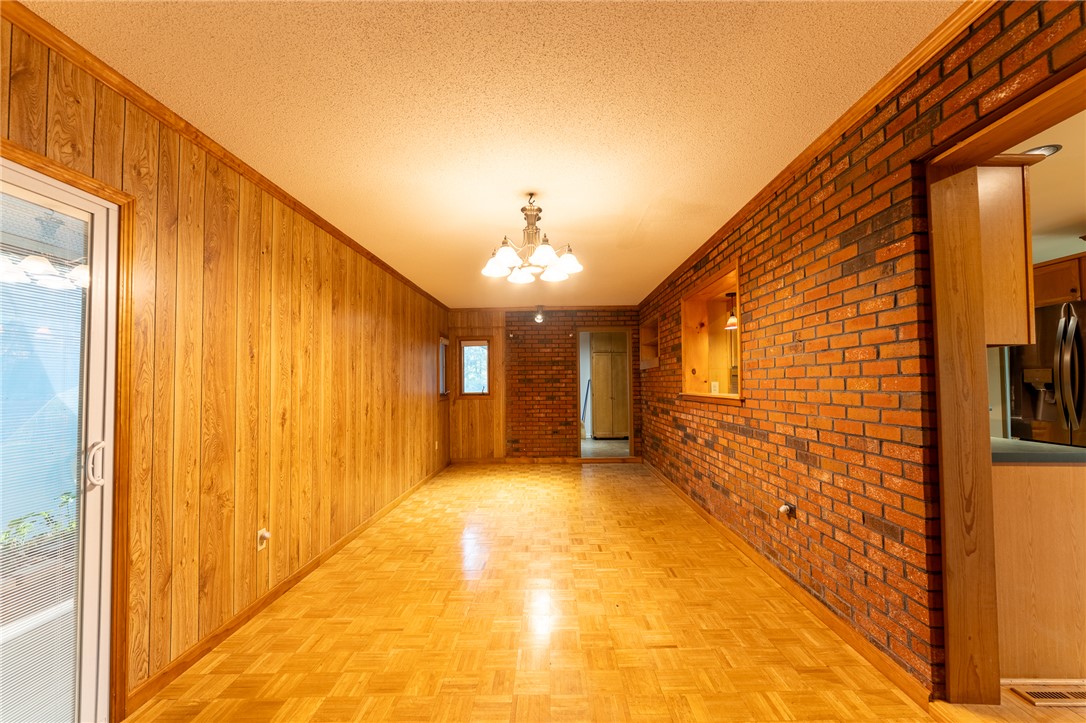 139 Todds Creek Road Central, SC 29630 - Photo 9 of 45 This versatile room features warm wood paneling, exposed brick, and hardwood floors.