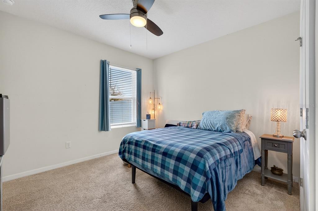 1809 Myrtlebrooke Drive Edgewater, FL 32141 - Photo 23 of 58 a bedroom with a bed and a lamp