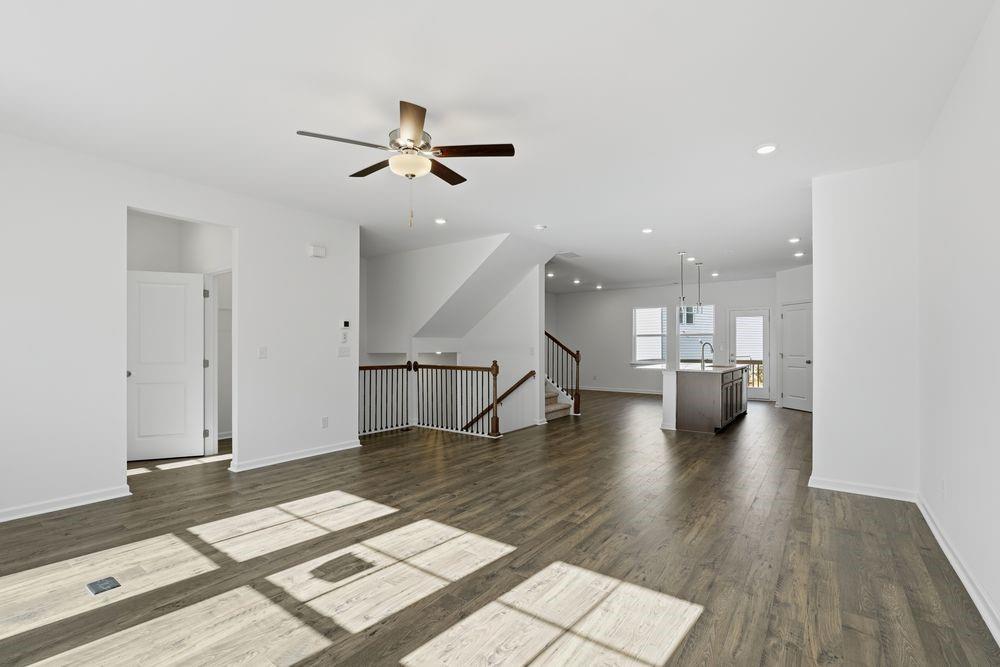 6121 Wayburn Street Tucker, GA 30084 - Photo 12 of 47 a view of a living room with wooden floor and a ceiling fan