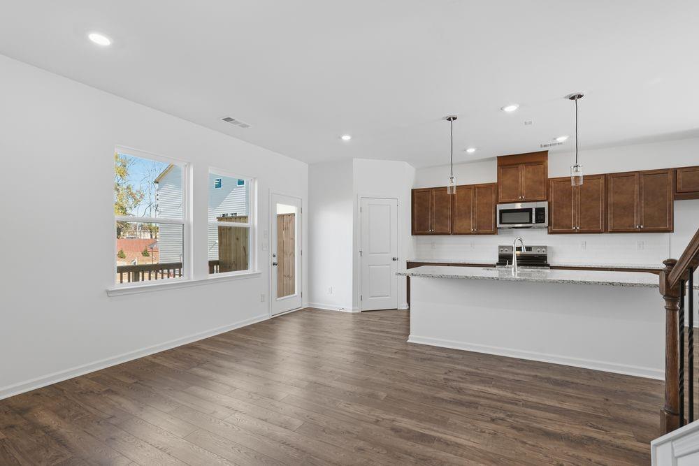 6121 Wayburn Street Tucker, GA 30084 - Photo 14 of 47 a view of kitchen with stainless steel appliances wooden floor and window