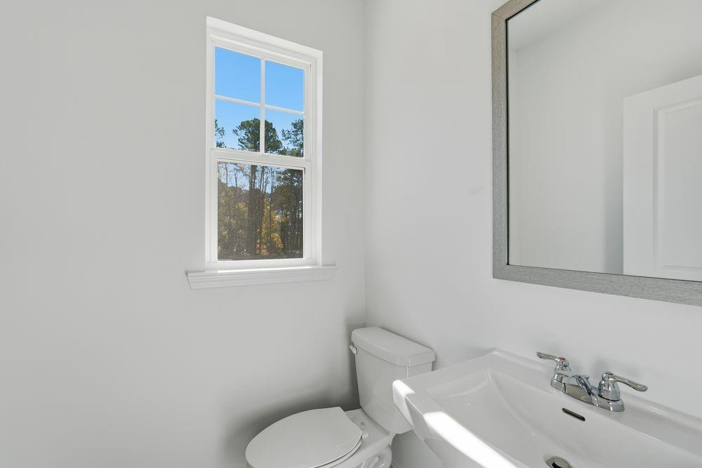 6121 Wayburn Street Tucker, GA 30084 - Photo 17 of 47 a bathroom with a toilet sink and mirror