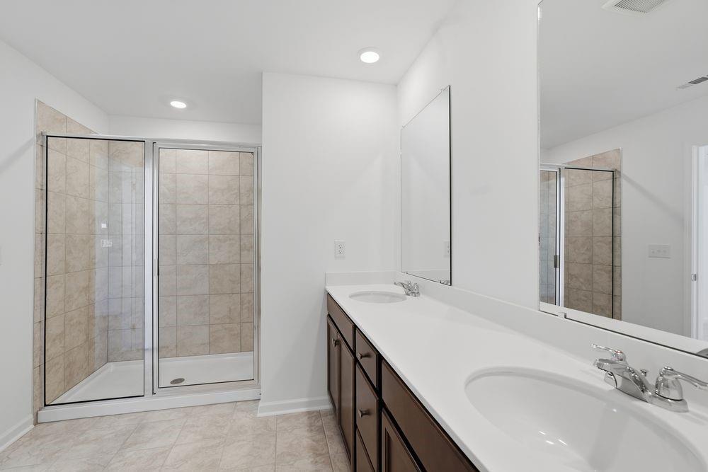 6121 Wayburn Street Tucker, GA 30084 - Photo 22 of 47 a bathroom with a double vanity sink mirror and shower