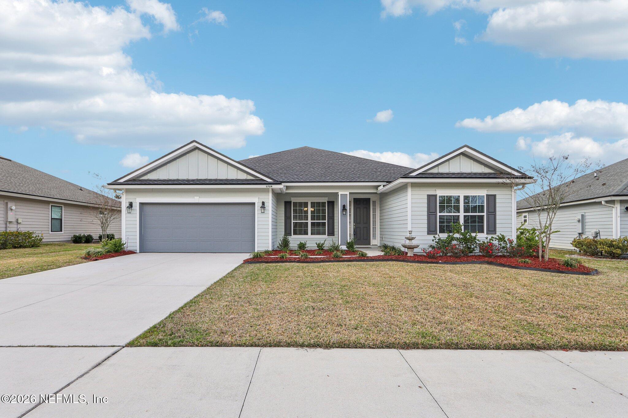 1724 Austin Lk Way Middleburg, FL 32068 - Photo 2 of 61 a front view of a house with a yard and garage