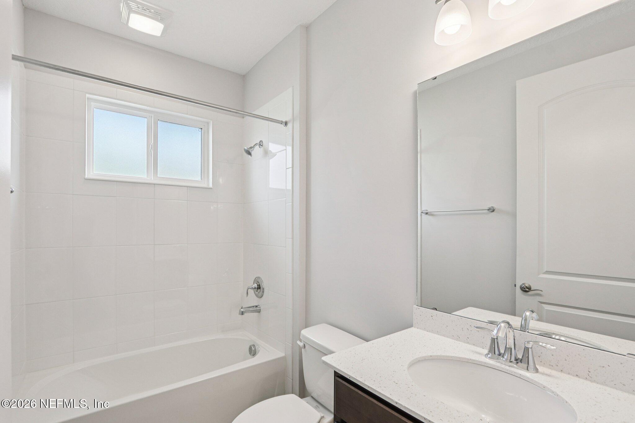 1724 Austin Lk Way Middleburg, FL 32068 - Photo 21 of 61 a bathroom with a granite countertop sink a toilet and shower