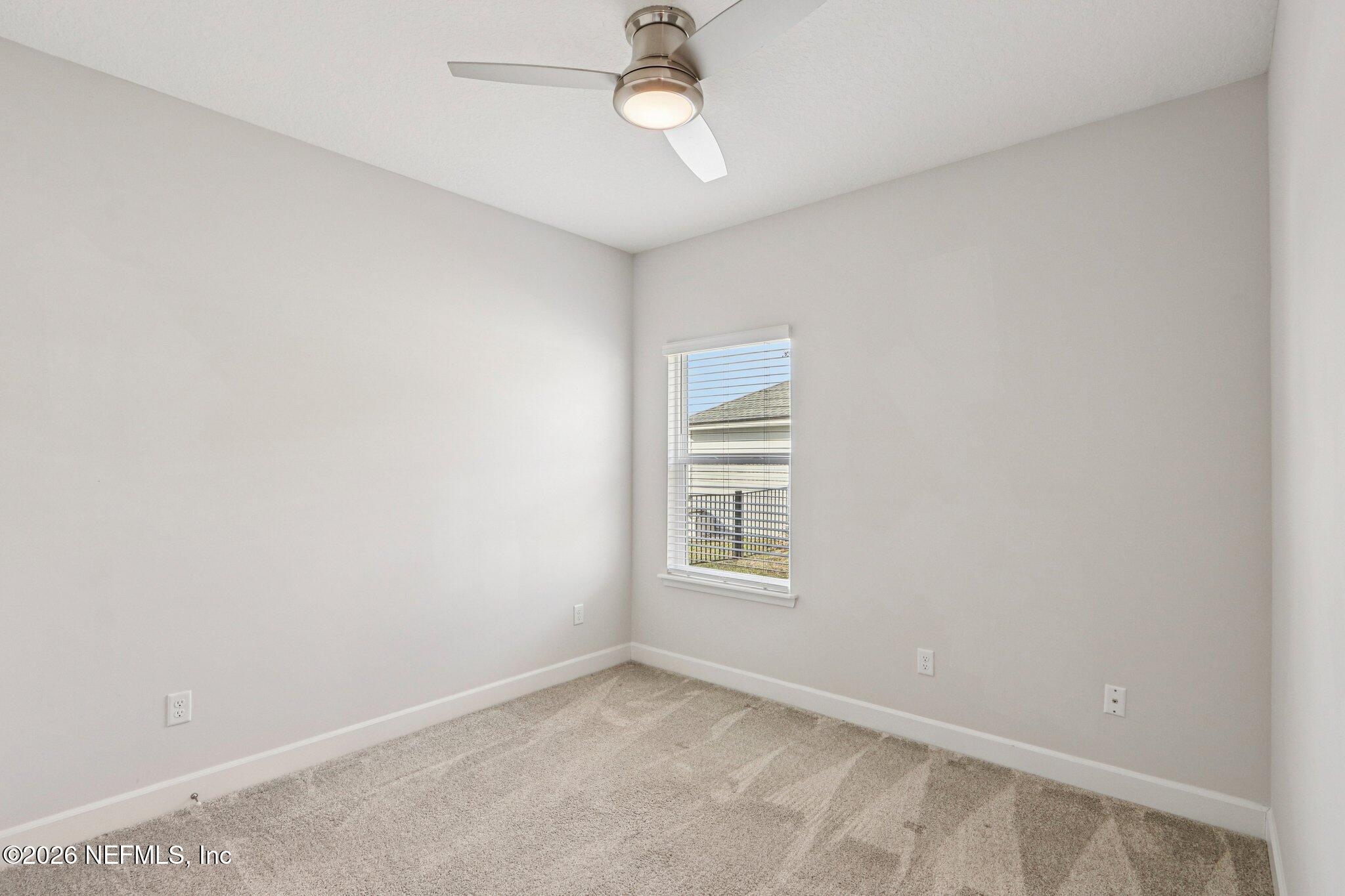 1724 Austin Lk Way Middleburg, FL 32068 - Photo 22 of 61 an empty room with windows and ceiling fan