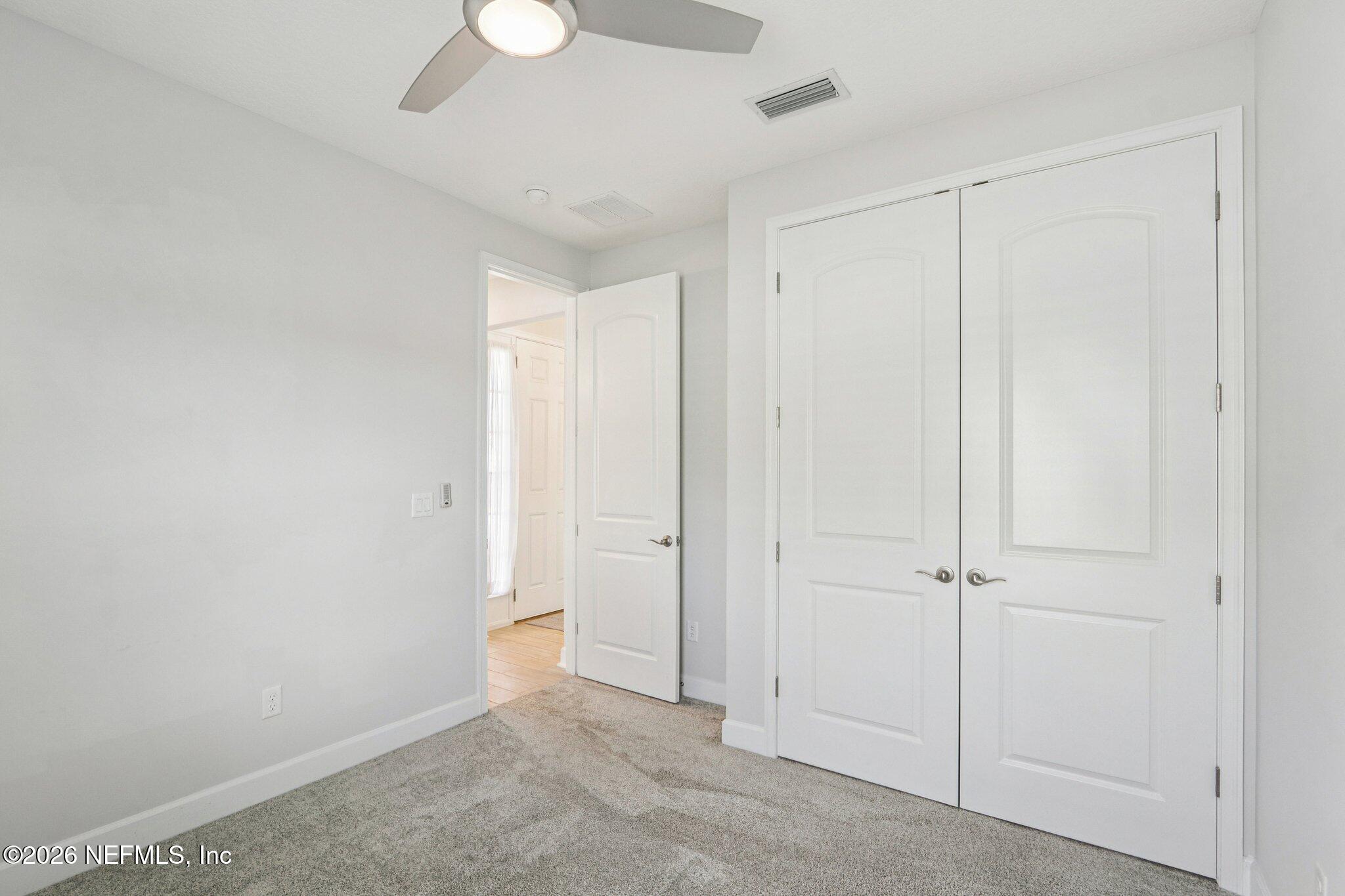 1724 Austin Lk Way Middleburg, FL 32068 - Photo 23 of 61 an empty room with a empty space and a ceiling fan