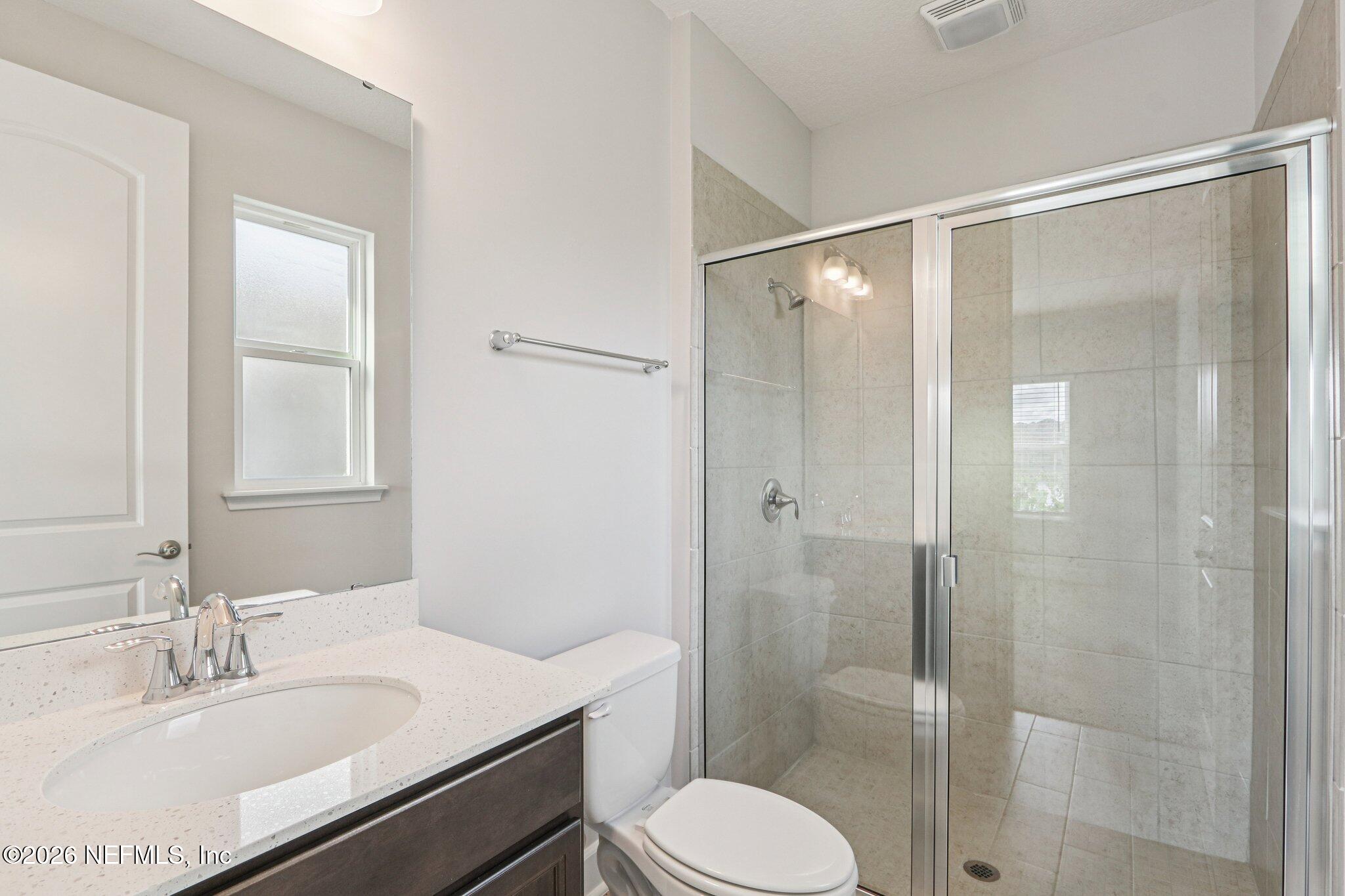 1724 Austin Lk Way Middleburg, FL 32068 - Photo 24 of 61 a bathroom with a sink toilet and shower