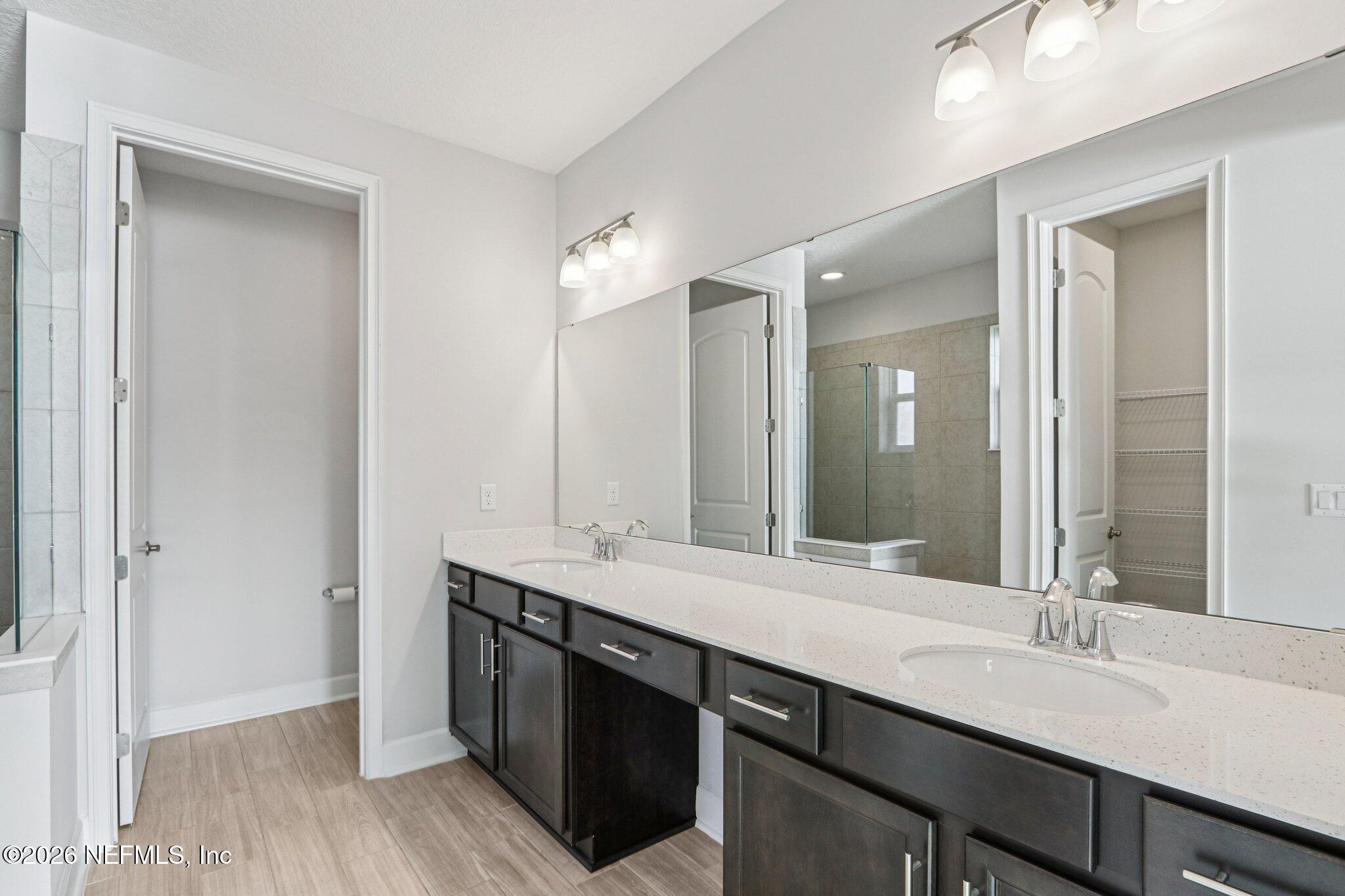 1724 Austin Lk Way Middleburg, FL 32068 - Photo 30 of 61 a bathroom with a granite countertop sink double and mirror