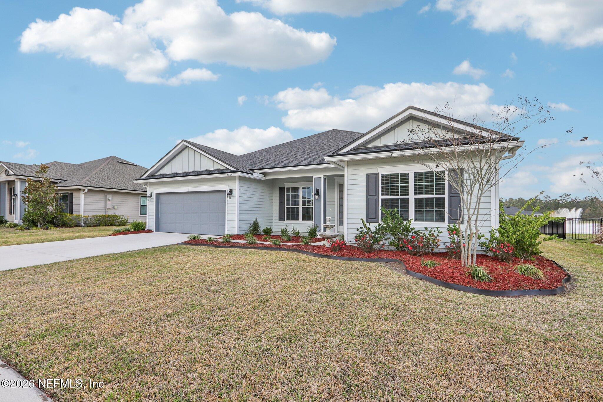 1724 Austin Lk Way Middleburg, FL 32068 - Photo 4 of 61 a front view of a house with yard and porch