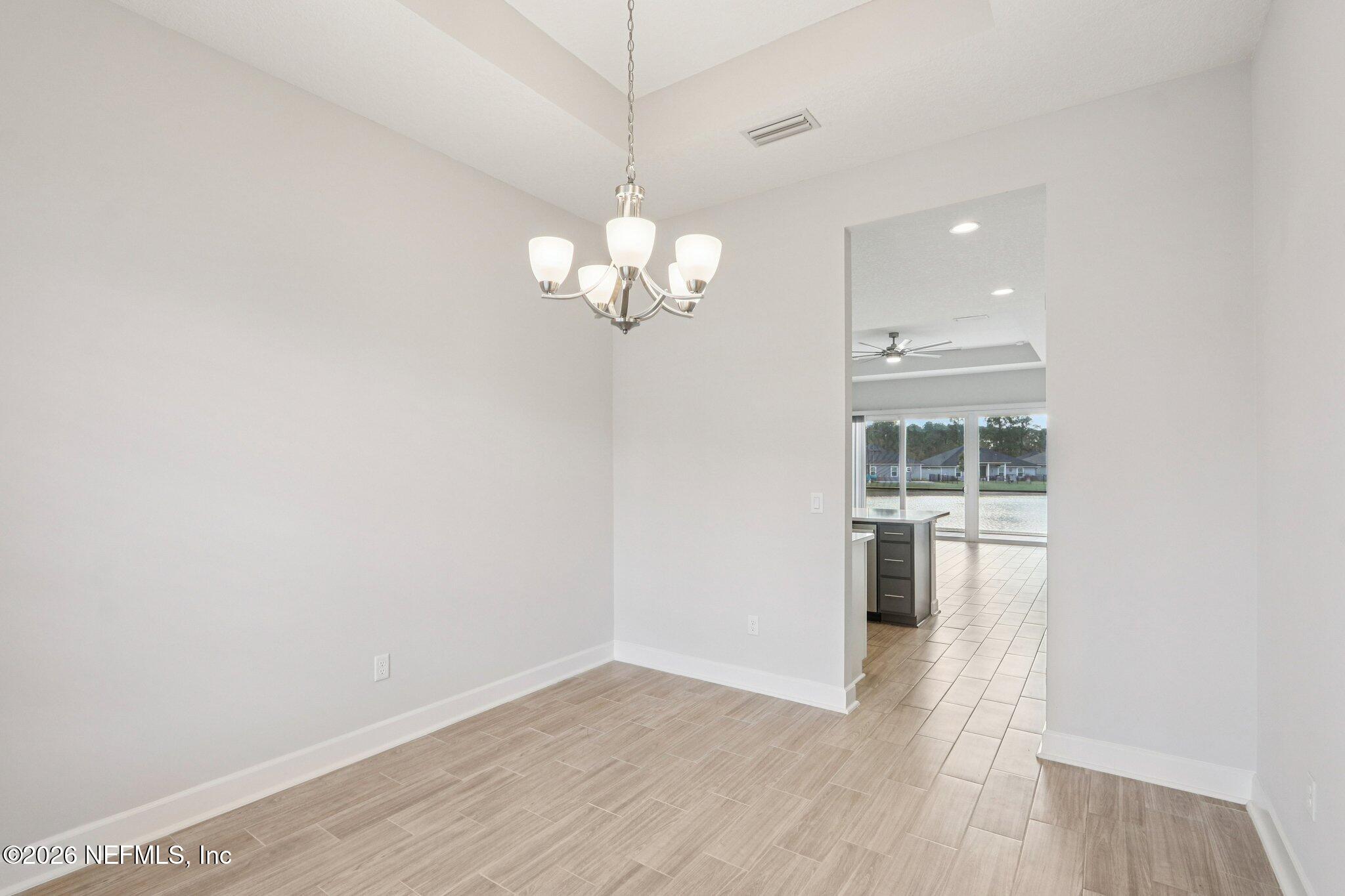 1724 Austin Lk Way Middleburg, FL 32068 - Photo 8 of 61 a view of a room with wooden floor and a window