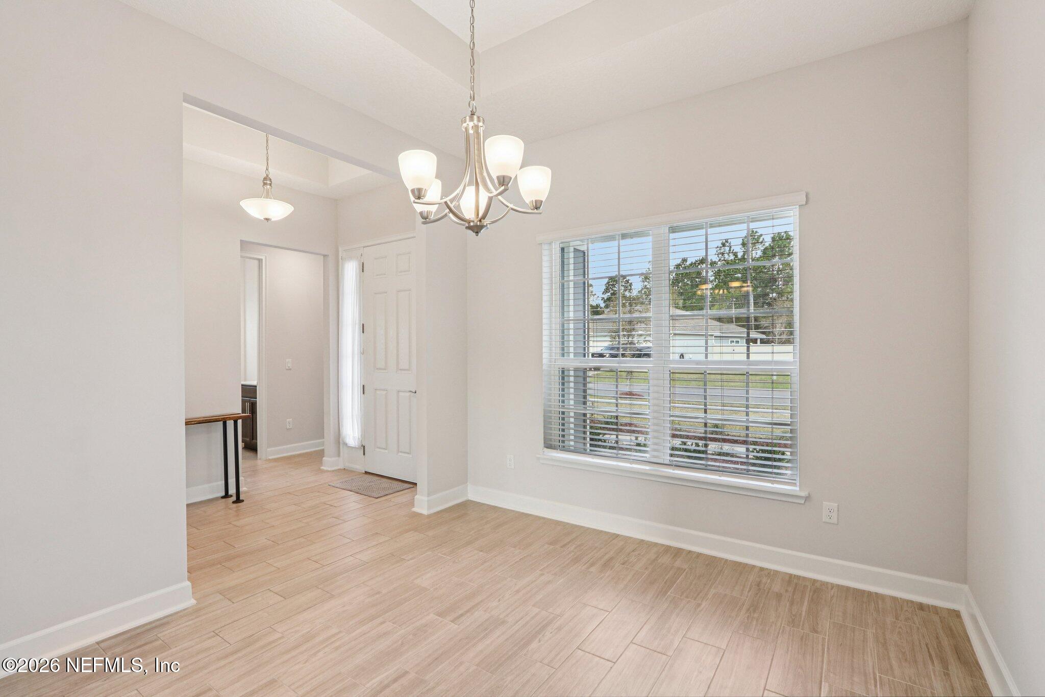 1724 Austin Lk Way Middleburg, FL 32068 - Photo 9 of 61 a view of a livingroom with a hardwood floor ceiling fan and window
