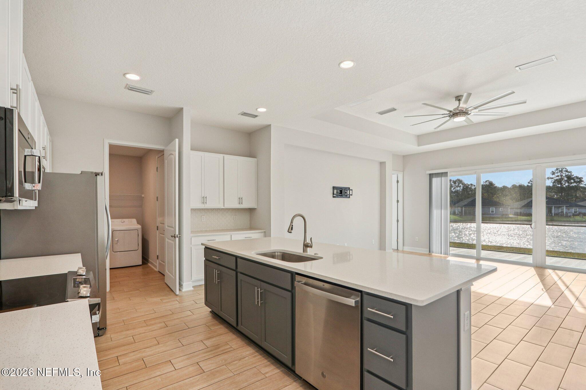 1724 Austin Lk Way Middleburg, FL 32068 - Photo 10 of 61 a kitchen with a sink appliances and cabinets