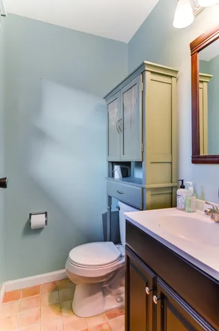 a bathroom with a sink mirror vanity and toilet