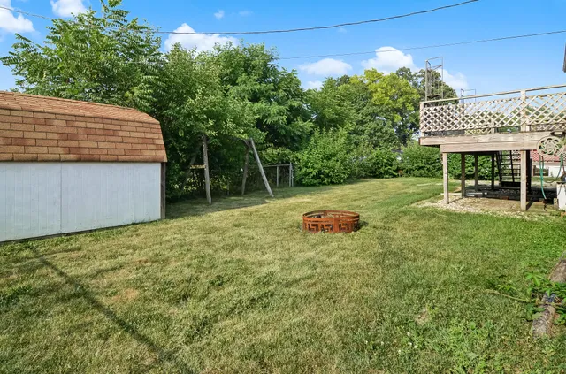 a backyard of a house with table and chairs