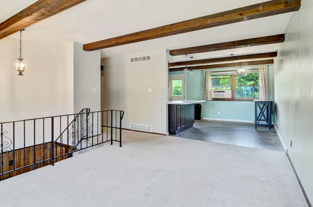 a open kitchen with a sink a table and chairs