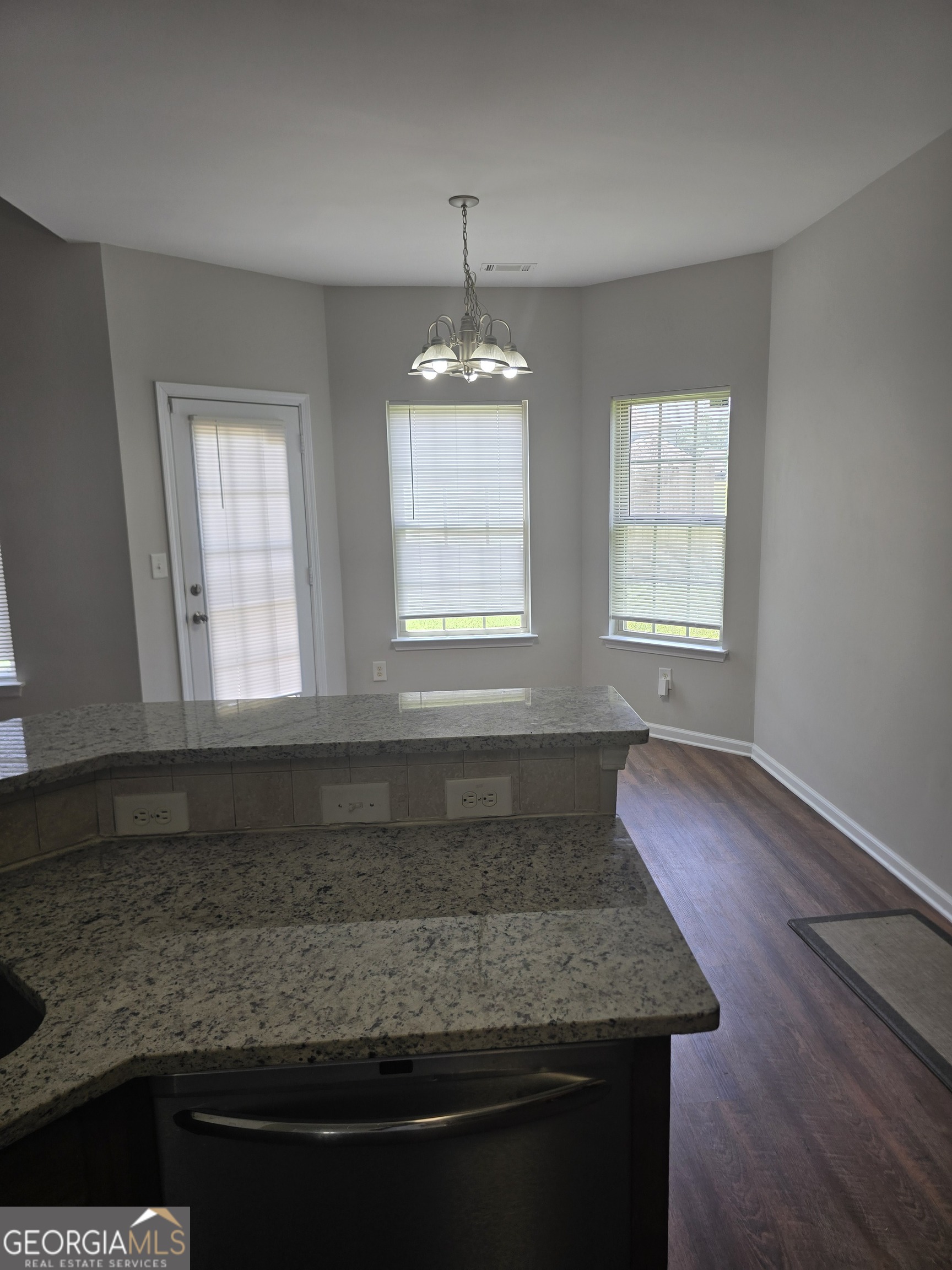 30 Vermillion Way Covington, GA 30016 - Photo 11 of 37 a kitchen with a stove and wooden floor