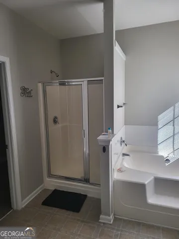 a bathroom with a shower and a sink