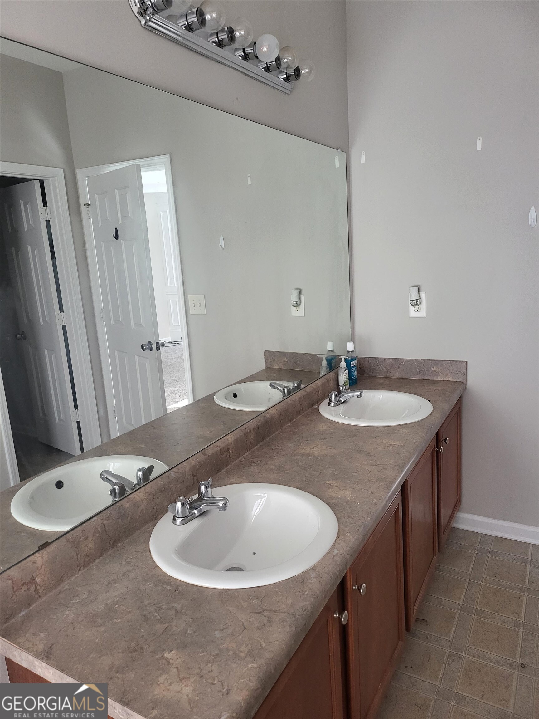 30 Vermillion Way Covington, GA 30016 - Photo 23 of 37 a bathroom with a sink and a mirror