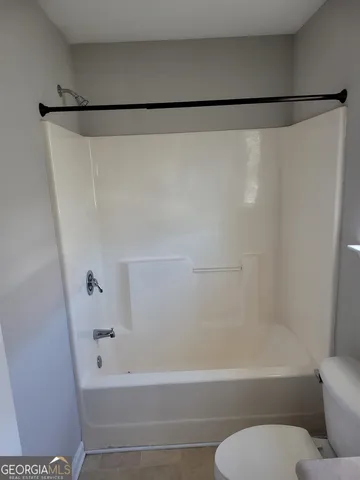 a bathroom with a shower and a toilet