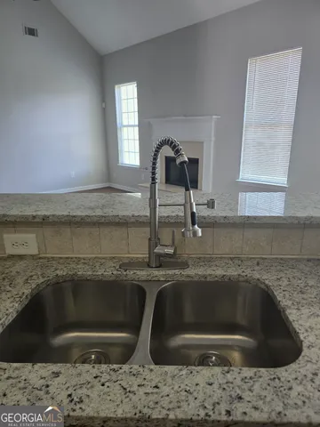a kitchen with a sink and granite top