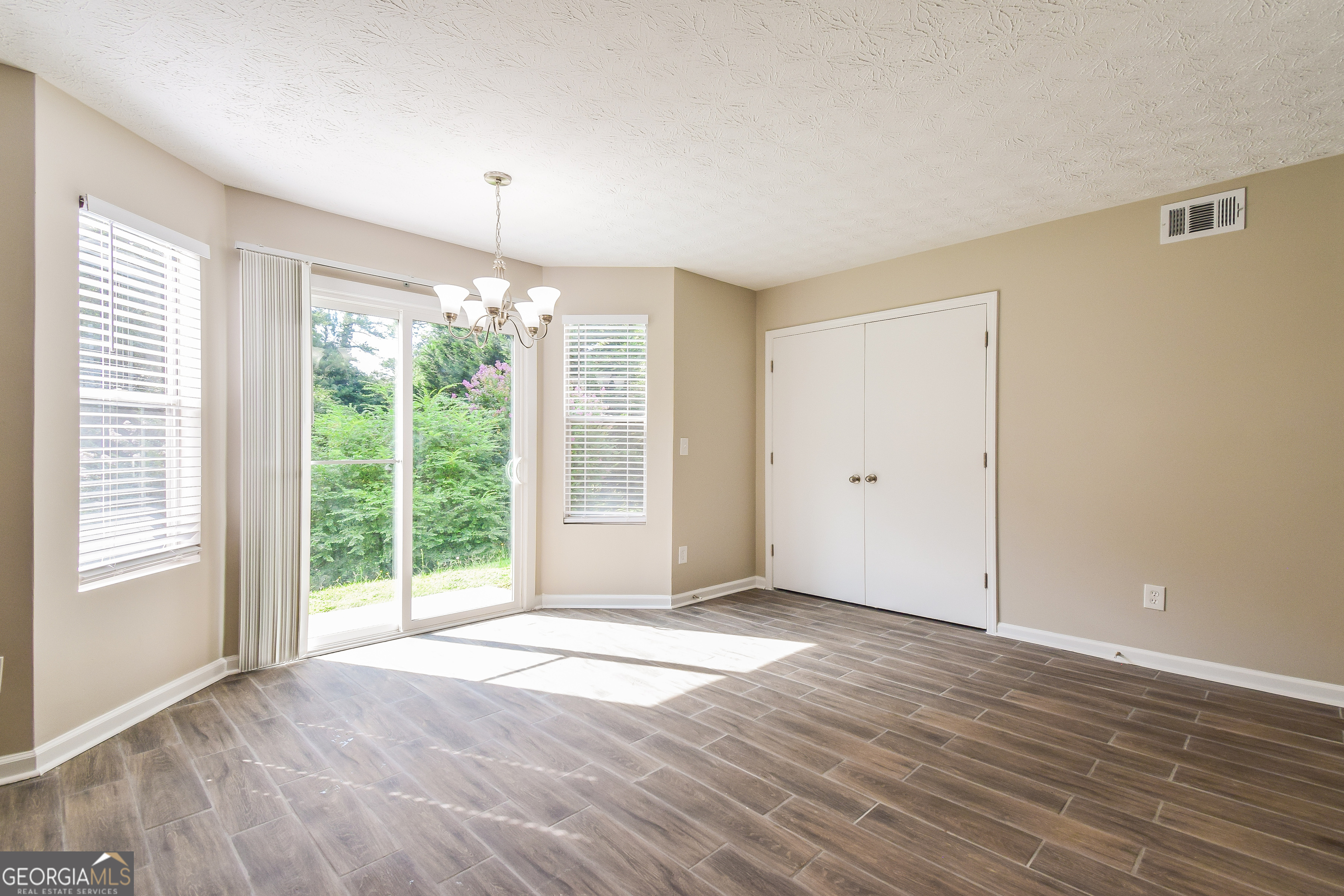 2826 Knollberry Lane Decatur, GA 30034 - Photo 4 of 17 a view of an empty room with wooden floor and a window