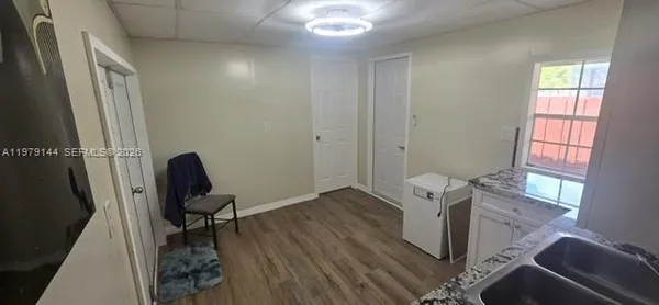 a view of a workspace with furniture and a window