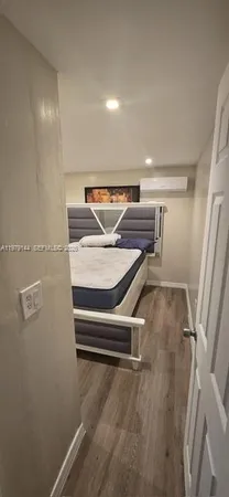 a room with wooden floor and white walls