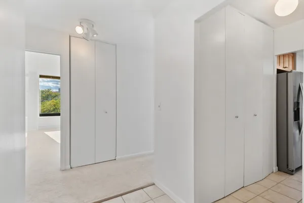 a view of a hallway with wooden floor
