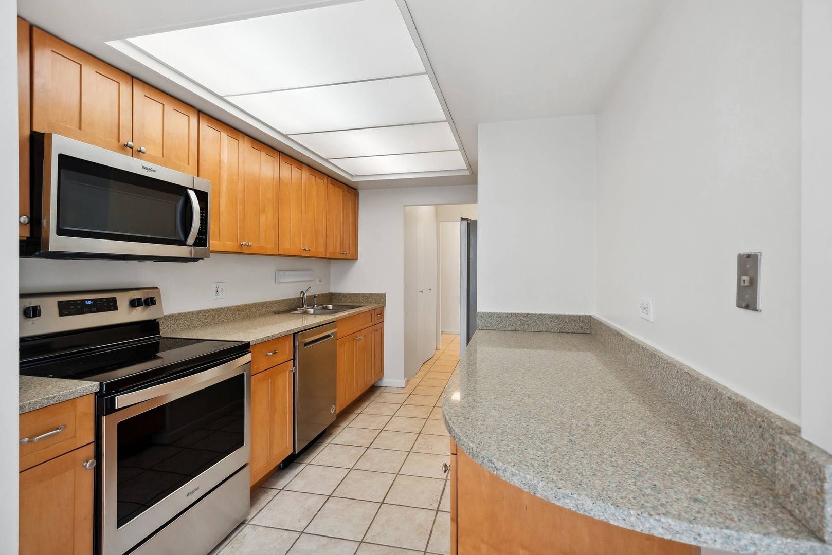 155 North Harbor Drive, Unit 403 Chicago, IL 60601 - Photo 7 of 24 a kitchen with stainless steel appliances granite countertop a stove a microwave and a sink