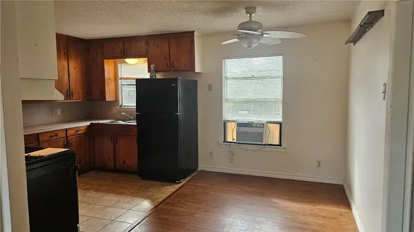a kitchen with a refrigerator and window
