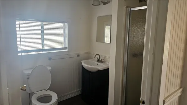 a bathroom with a sink toilet and shower