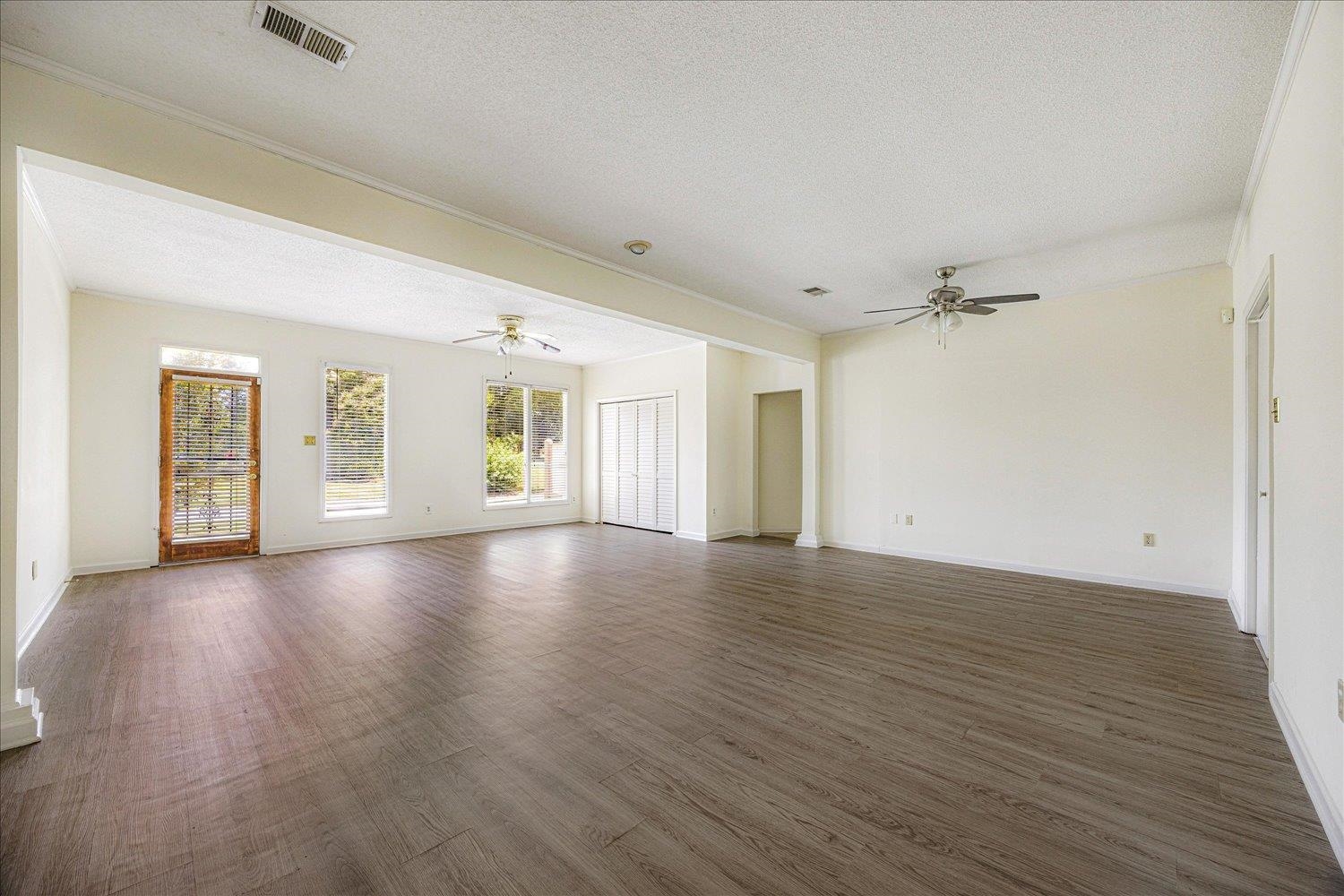 7944 Anne's Circle Memphis, TN 38018 - Photo 14 of 27 an empty room with wooden floor and windows
